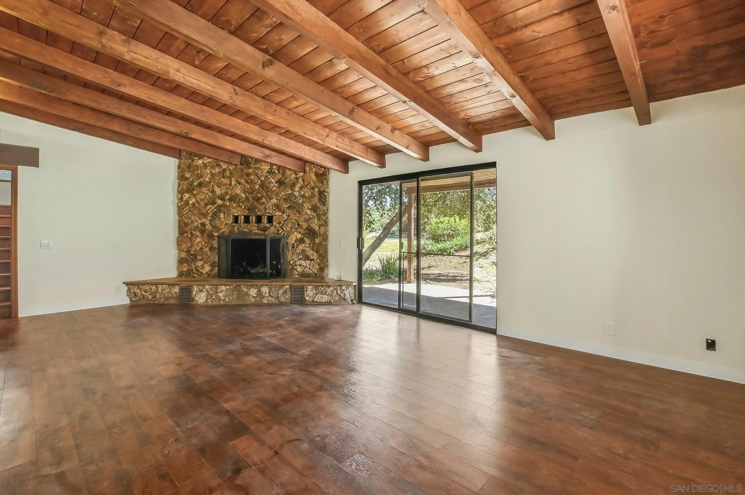 9907 Anderson Ranch Road Descanso, CA 91916 - Photo 9 of 42 a view of an empty room with wooden floor and a window