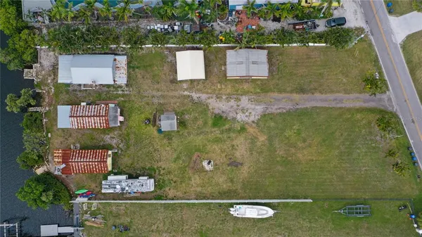 an aerial view of ocean with residential house and outdoor space