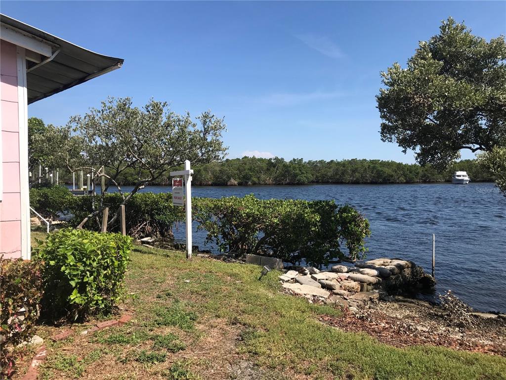 3306 West Shell Point Road Ruskin, FL 33570 - Photo 9 of 10 a backyard of a house with lots of green space and lake view