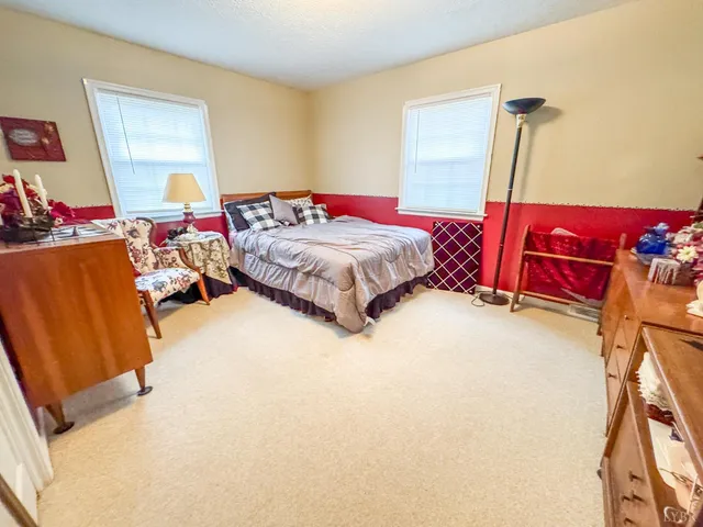 a bedroom with bed and a window