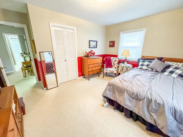 a bedroom with furniture and a window