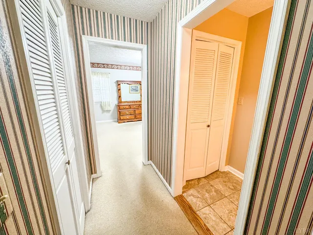 a spacious bedroom with a bed and a window