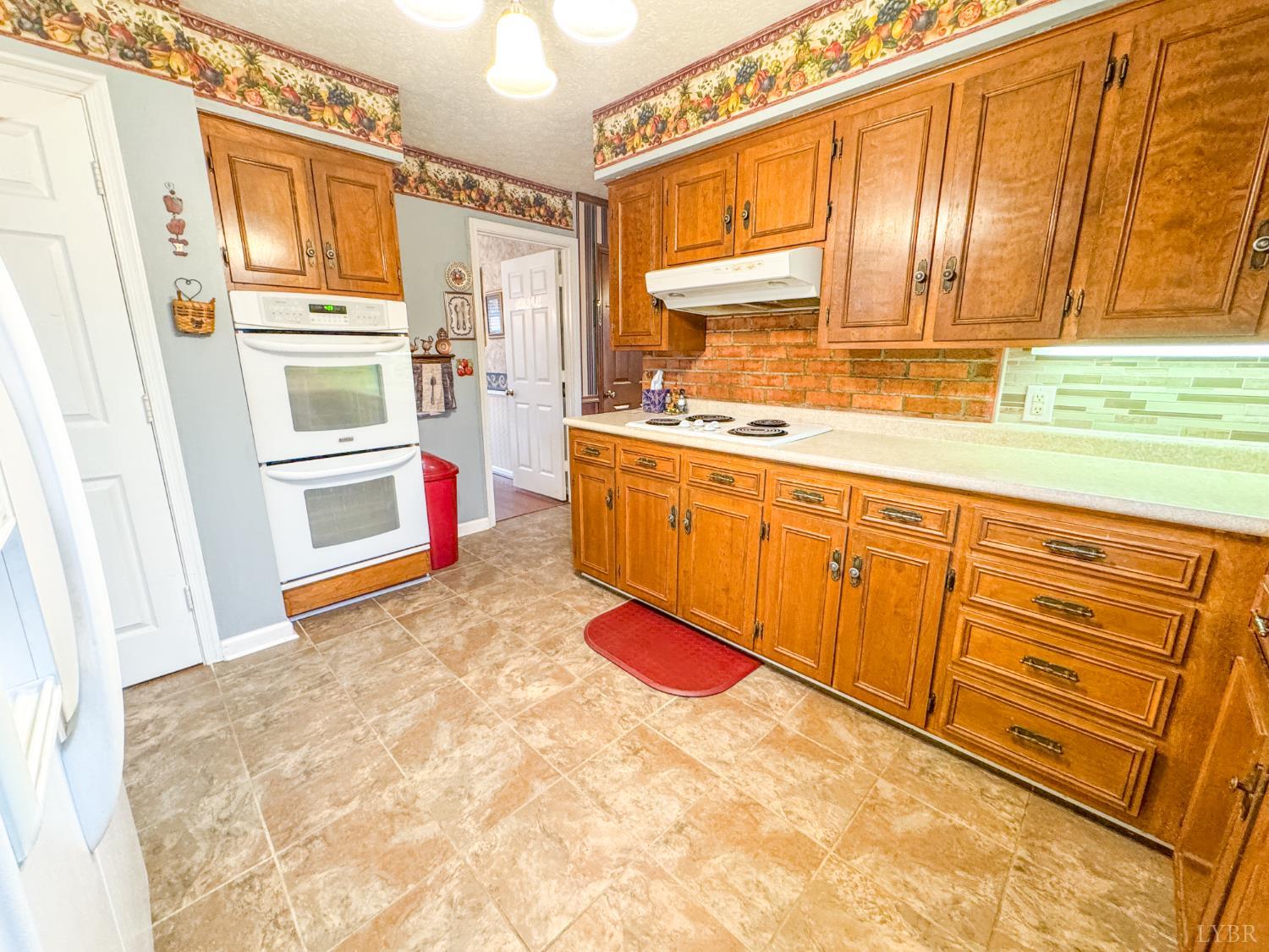 88 Jean Place Evington, VA 24550 - Photo 10 of 46 a kitchen with stainless steel appliances granite countertop a refrigerator and a sink