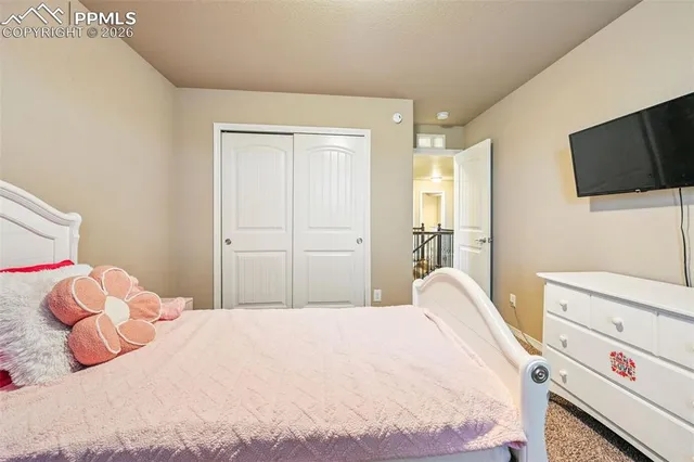 a bedroom with a bed and flat screen tv