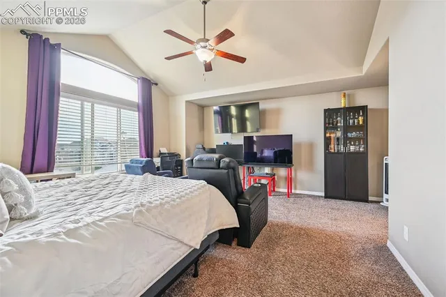 a bedroom with a bed a window and a chandelier