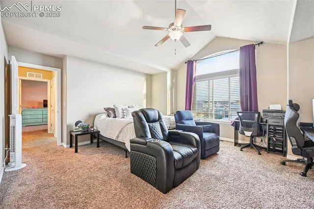 a living room with furniture ceiling fan and a window