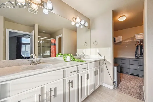 a bathroom with a double vanity sink and a mirror