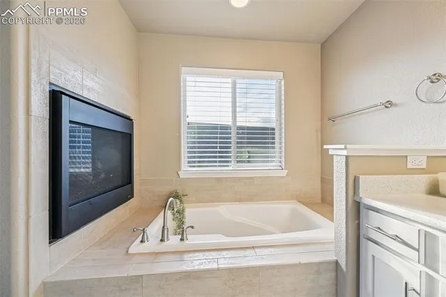 a bathroom with a bathtub and a sink