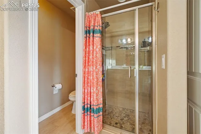 a bathroom with a shower and a glass door