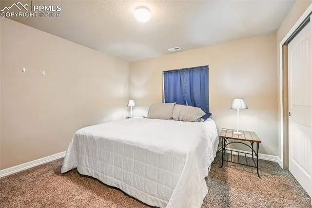 a bedroom with a bed and a cabinets