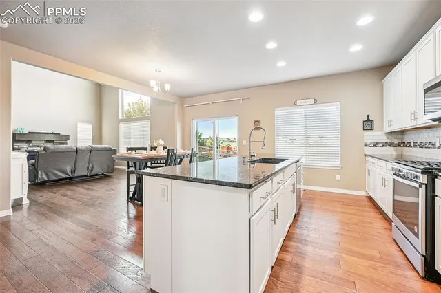 a large kitchen with stainless steel appliances lots of counter top space