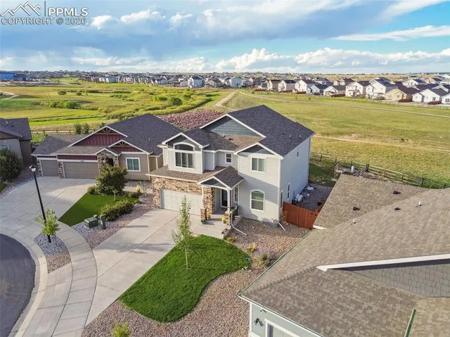 an aerial view of a house with outdoor space