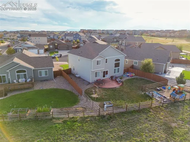 a view of a house with a big yard and large trees