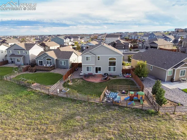 an aerial view of residential houses with outdoor space