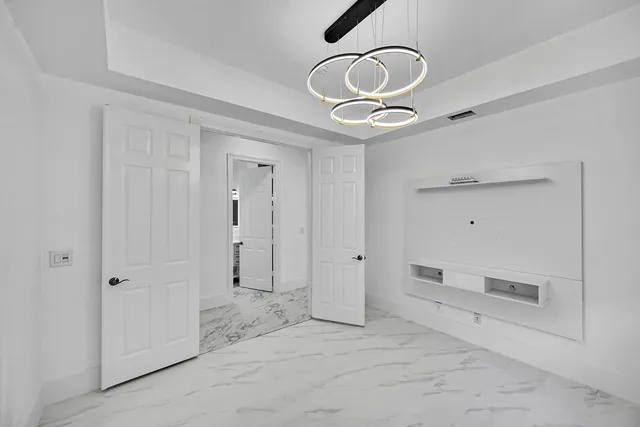 a bathroom with a granite countertop sink a mirror and shower