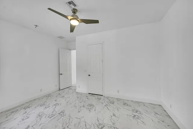a view of a house with a tree in the yard