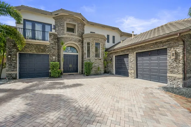 a kitchen with stainless steel appliances kitchen island granite countertop a refrigerator and a stove top oven