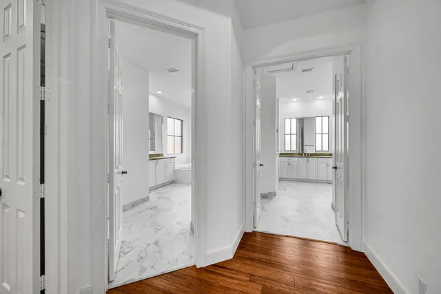 an aerial view of a houses with a swimming pool