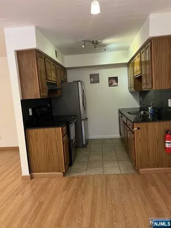 a view of a kitchen with electric appliances