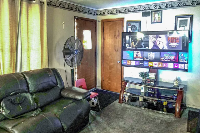 a living room with furniture a rug and a window