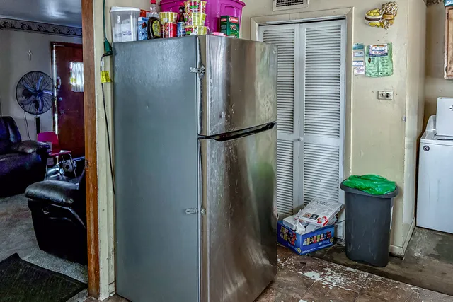 a room with water heater and refrigerator