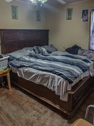 a bed sitting in a bedroom next to a lamp