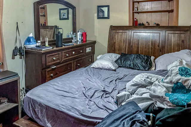 a bed room with a bed and a television