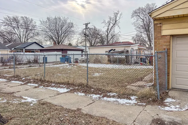 a view of a house with a yard covered in snow