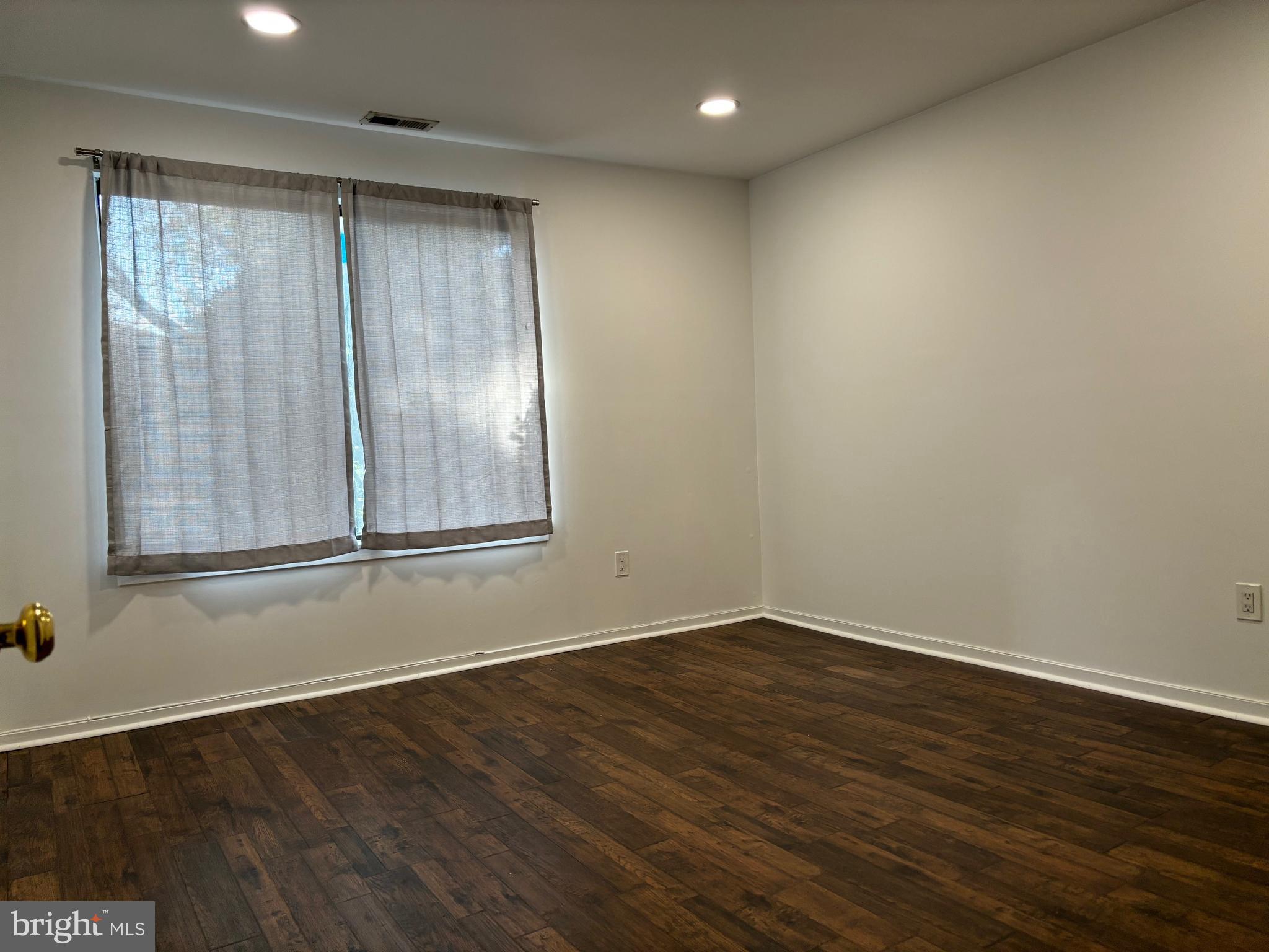101 Gregorys Way Voorhees, NJ 08043 - Photo 13 of 16 a view of an empty room with wooden floor and a window