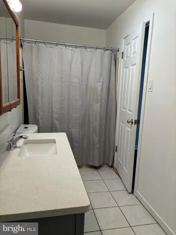 a bathroom with a shower and a sink