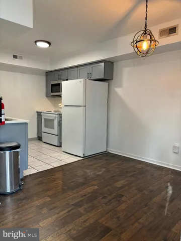 a view of kitchen with furniture and wooden floor