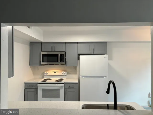 a kitchen with a refrigerator and a stove