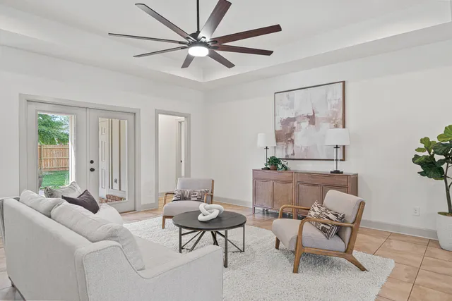 a living room with furniture and a potted plant