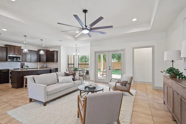 a kitchen with stainless steel appliances granite countertop a sink a stove a refrigerator and island