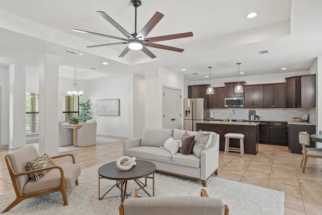 a kitchen with stainless steel appliances granite countertop a sink refrigerator and cabinets