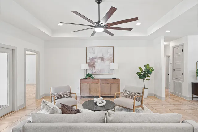 a kitchen with stainless steel appliances granite countertop a sink a stove a refrigerator and chairs