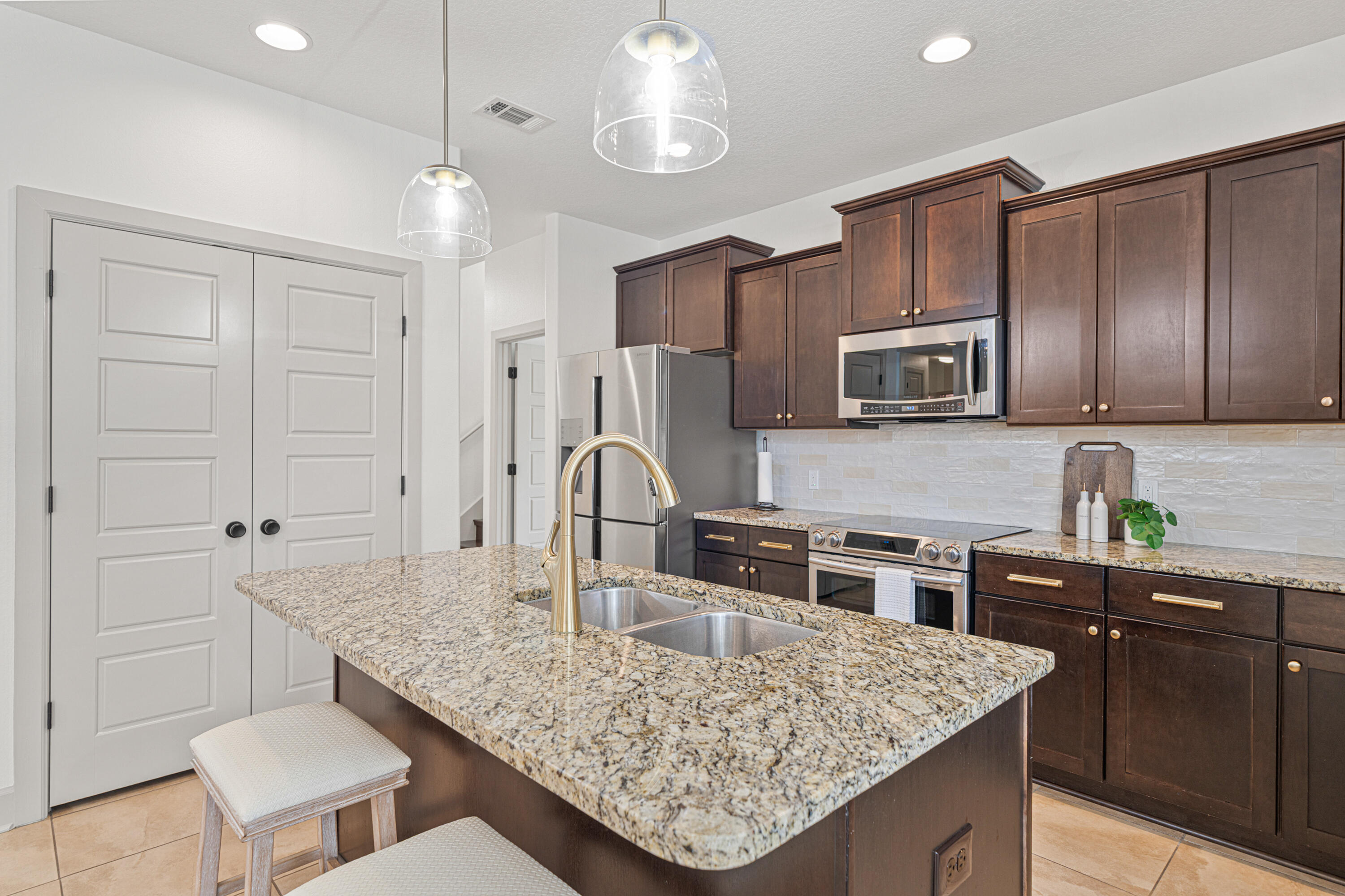 6301 Antigone Circle Crestview, FL 32536 - Photo 21 of 82 a kitchen with stainless steel appliances granite countertop a sink refrigerator and cabinets