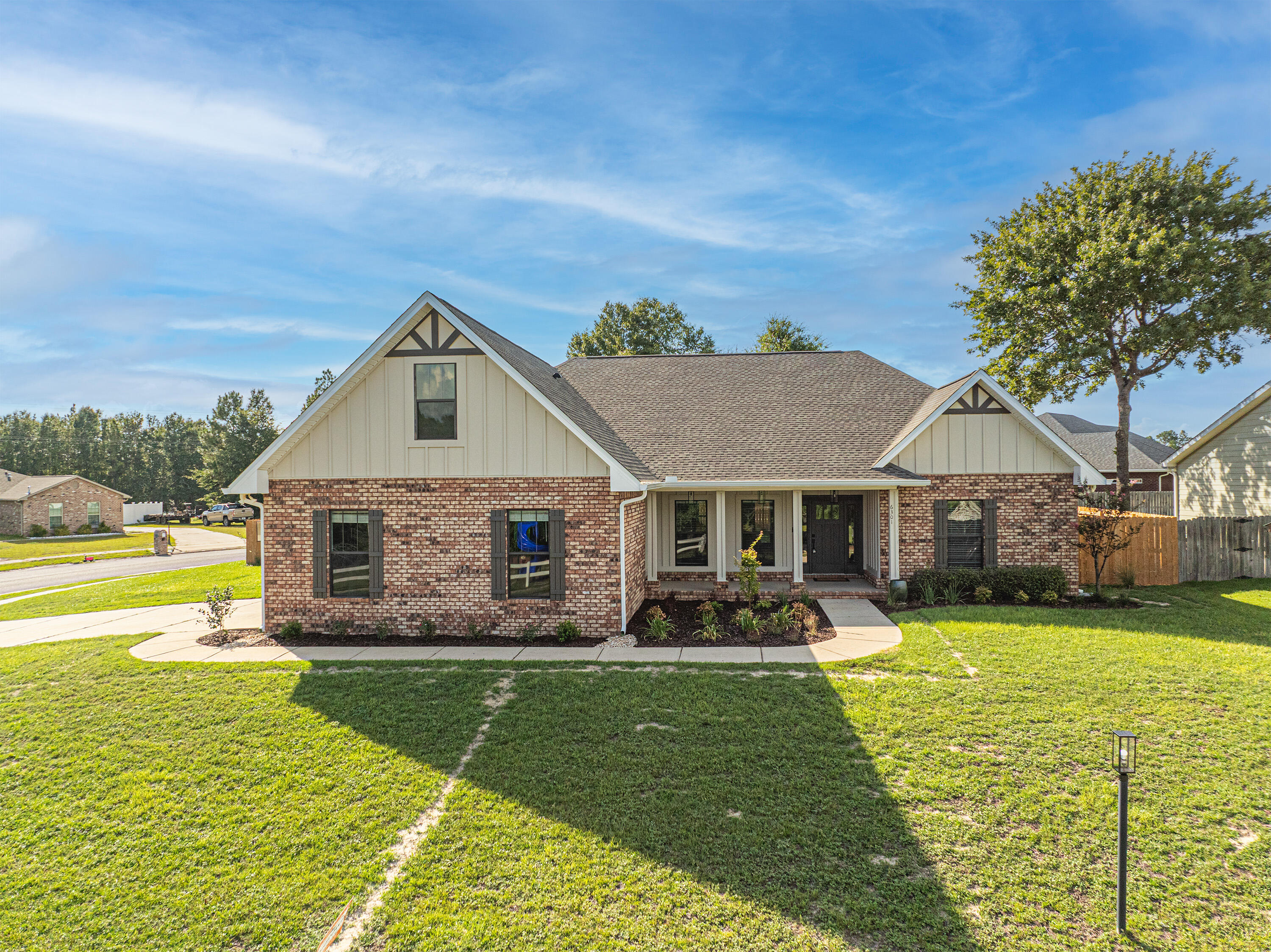 6301 Antigone Circle Crestview, FL 32536 - Photo 3 of 82 a view of a house with a big yard potted plants and large tree