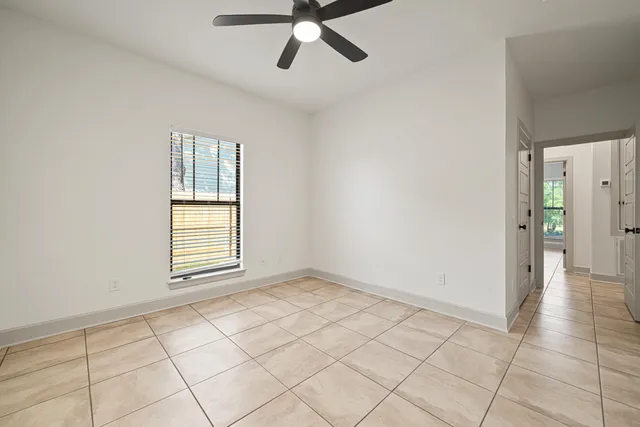 a bathroom with a granite countertop toilet a sink and a mirror