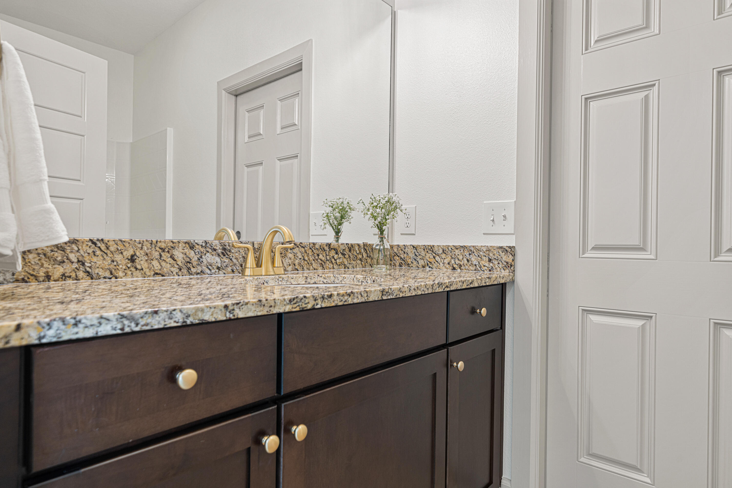 6301 Antigone Circle Crestview, FL 32536 - Photo 53 of 82 a bathroom with a granite countertop sink and a mirror