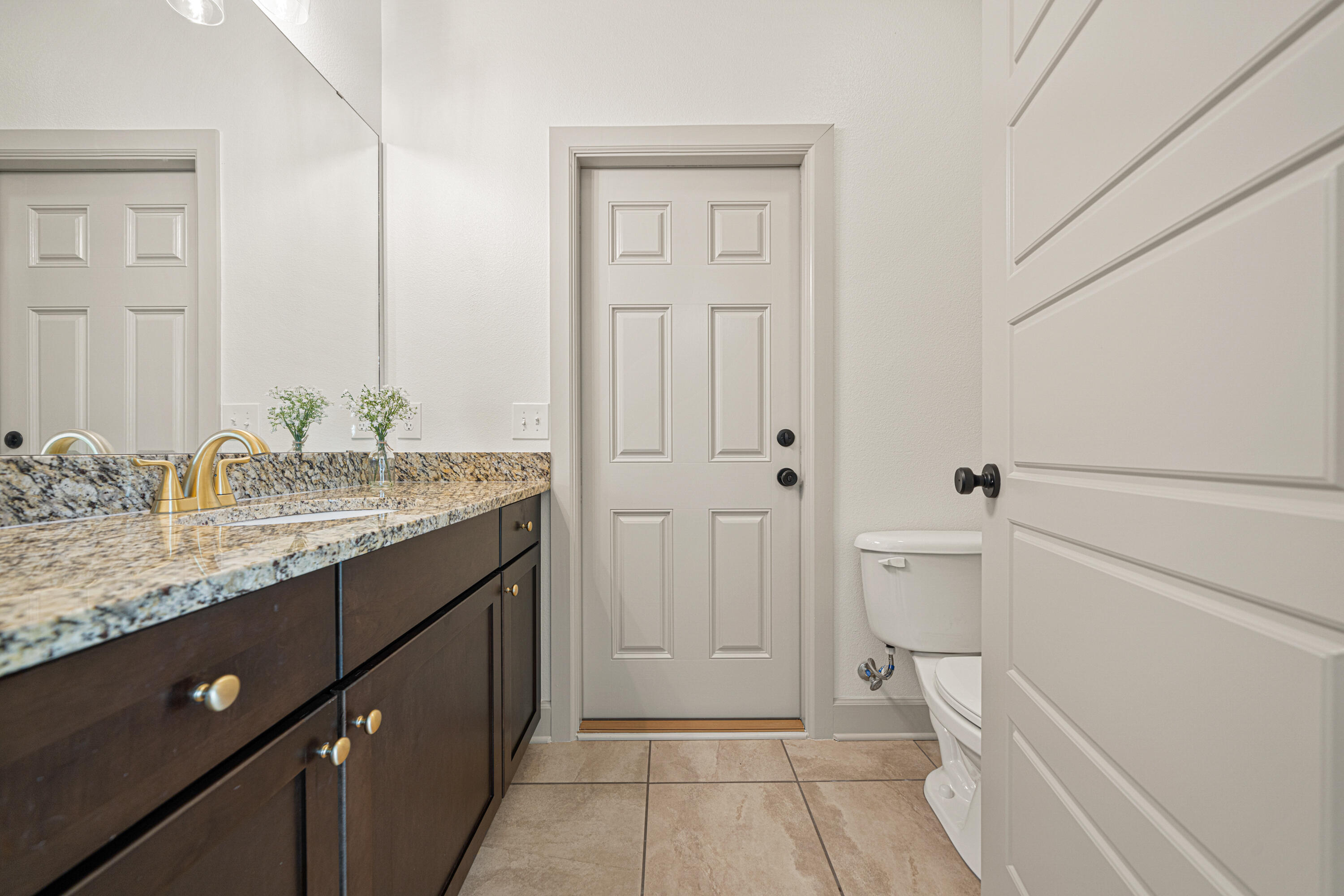 6301 Antigone Circle Crestview, FL 32536 - Photo 56 of 82 a bathroom with a granite countertop sink and a mirror