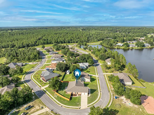 a view of a dining room with furniture and a chandelier