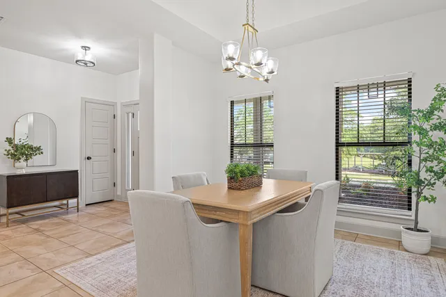 a living room with furniture and a view of kitchen