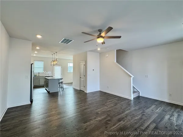 a view of an empty room and wooden floor
