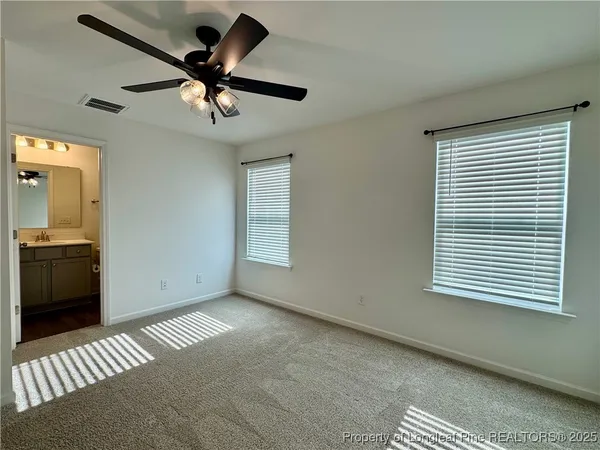 a view of a livingroom with a ceiling fan and window
