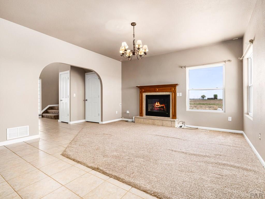 43948 Hunsaker Road Avondale, CO 81022 - Photo 9 of 56 a view of an empty room with a fireplace and a window