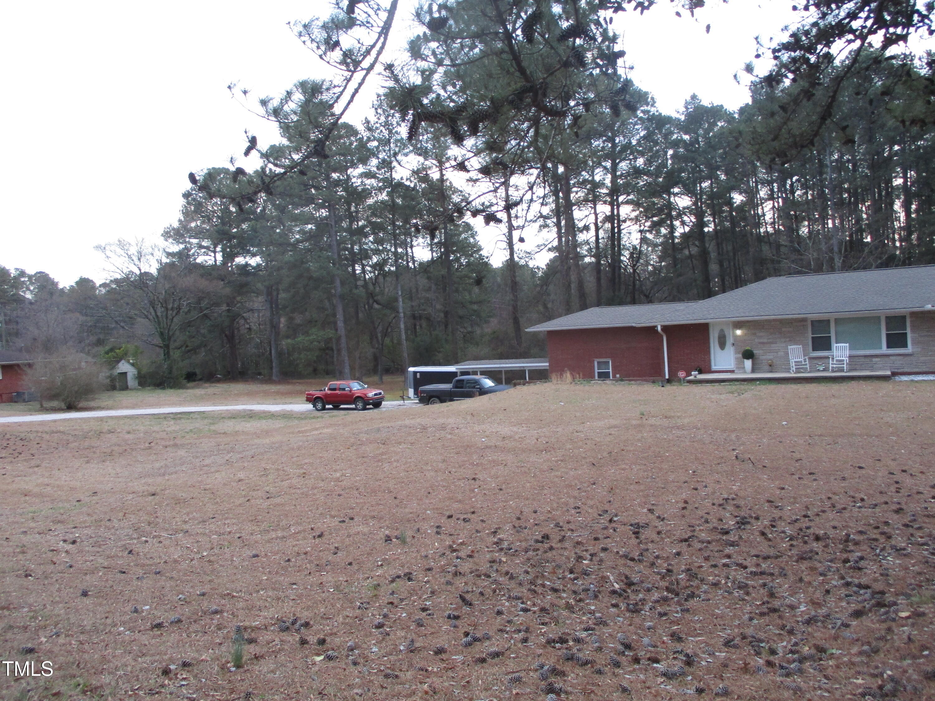 2506 Poole Road Raleigh, NC 27610 - Photo 2 of 6 a view of backyard with large trees and wooden fence