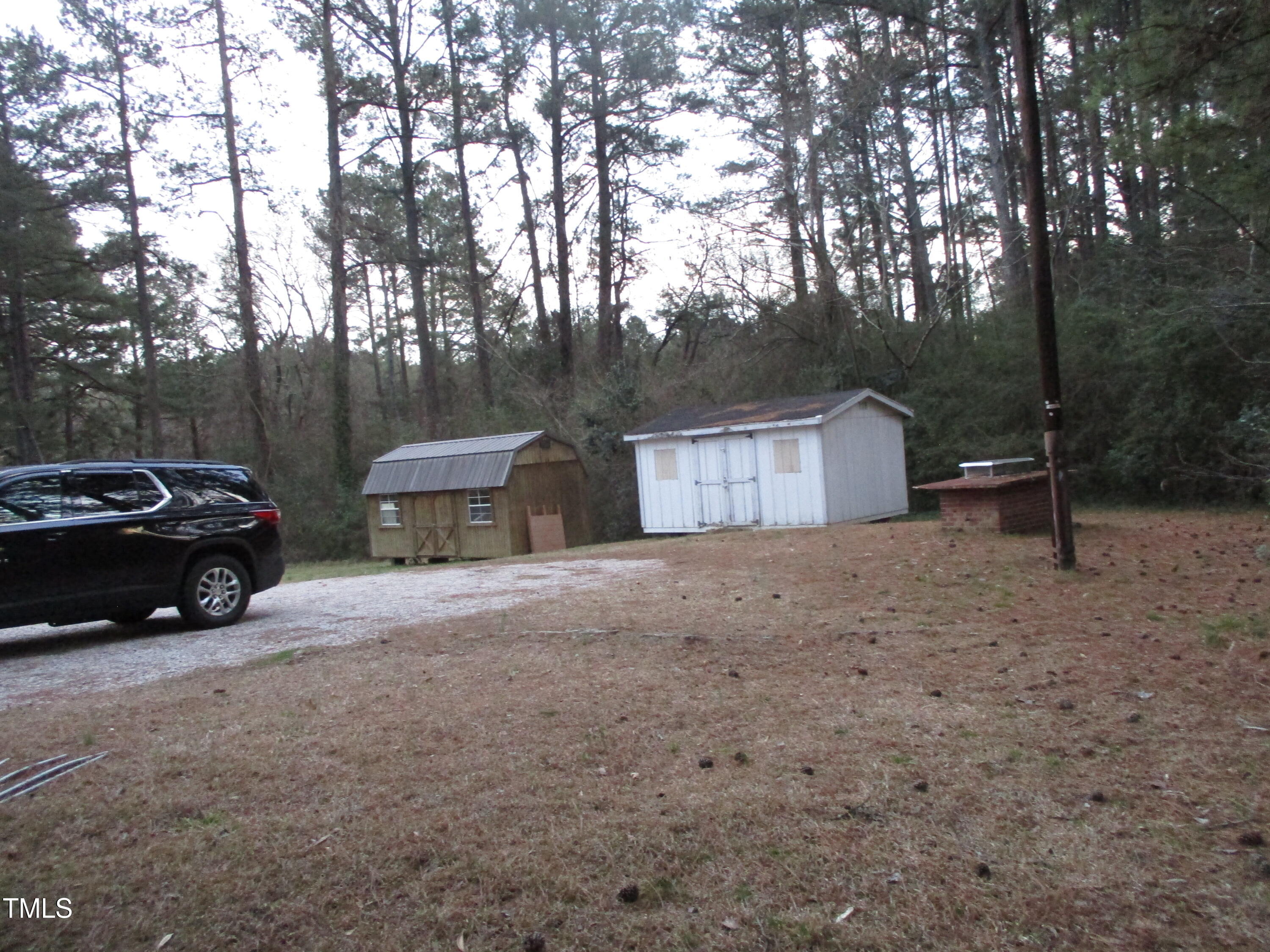 2506 Poole Road Raleigh, NC 27610 - Photo 3 of 6 a view of a house with a yard and parked area