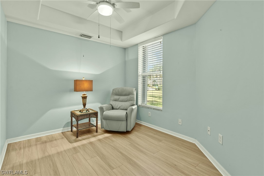 9575 Hemingway Lane, Unit 4410 Fort Myers, FL 33913 - Photo 12 of 23 a living room with furniture and a lamp
