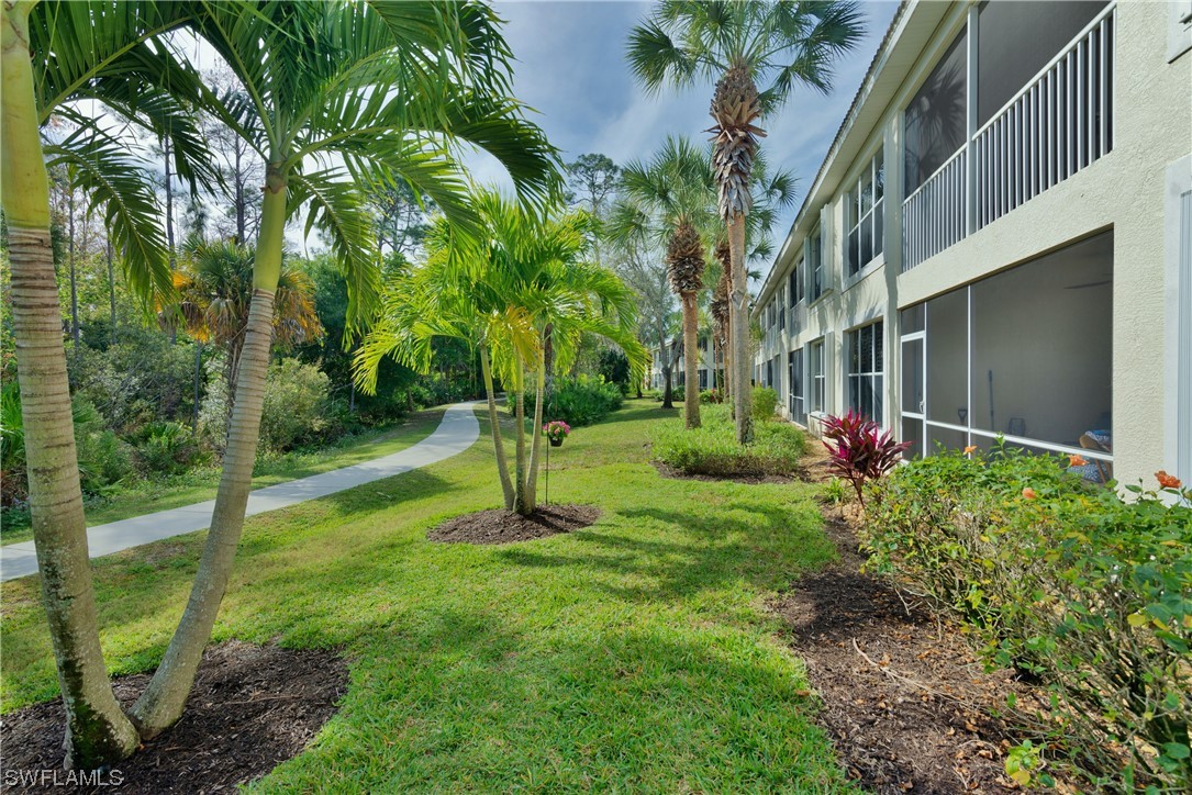 9575 Hemingway Lane, Unit 4410 Fort Myers, FL 33913 - Photo 7 of 23 a front view of a house with a yard